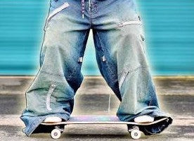 Skater with baggy pants standing on skateboard